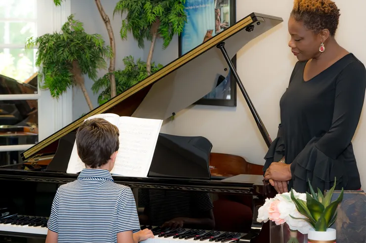 Vivia Taylor watches a student play piano