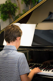 A young student plays piano.