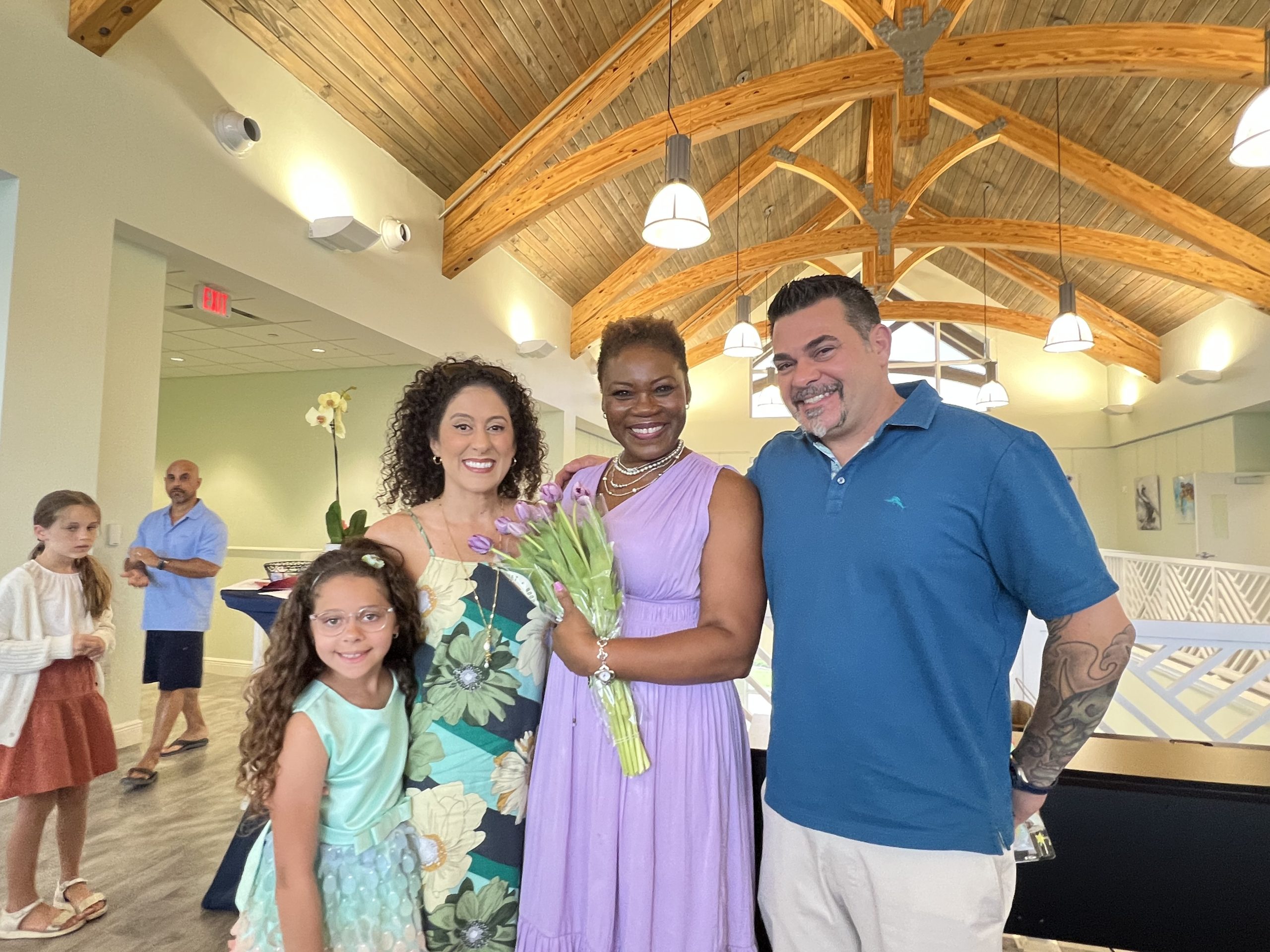 Music teacher Vivia Taylor stands with a student and her family.