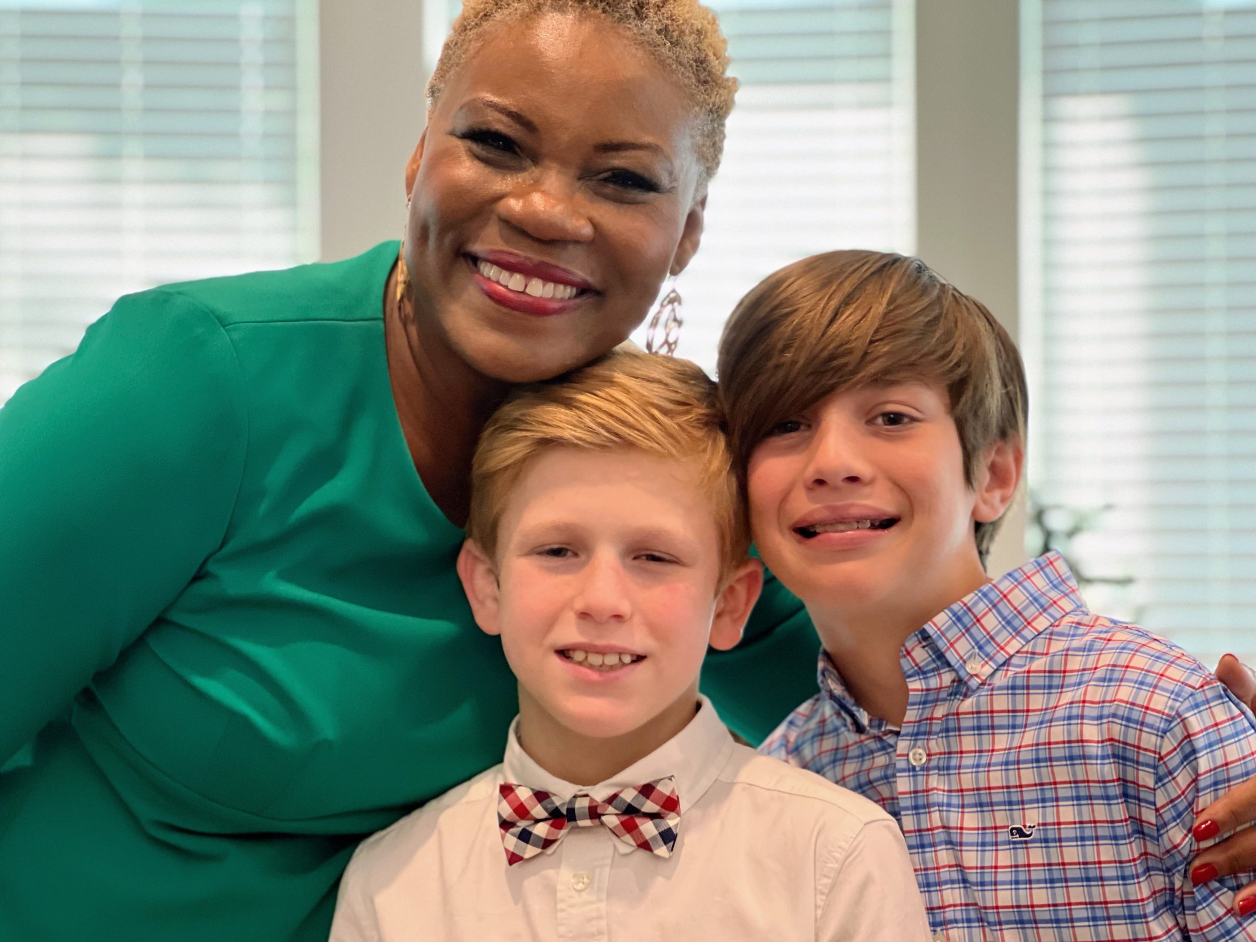 Vivia Taylor stands with two young music students.
