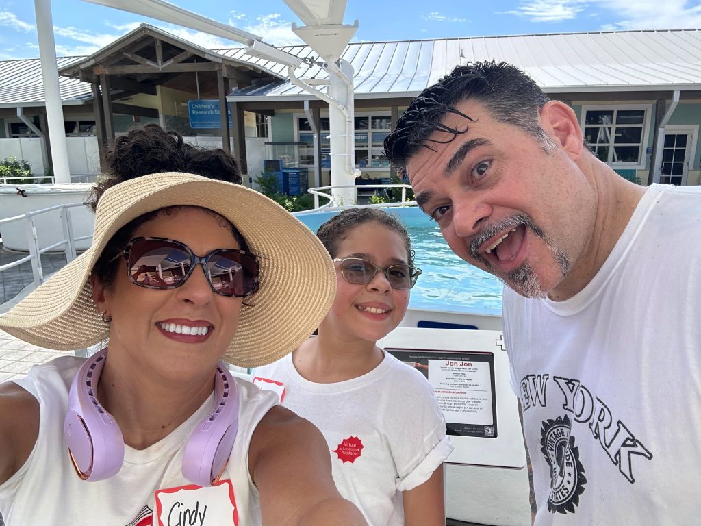 A music student and her parents at the Loggerhead Marinelife Center.
