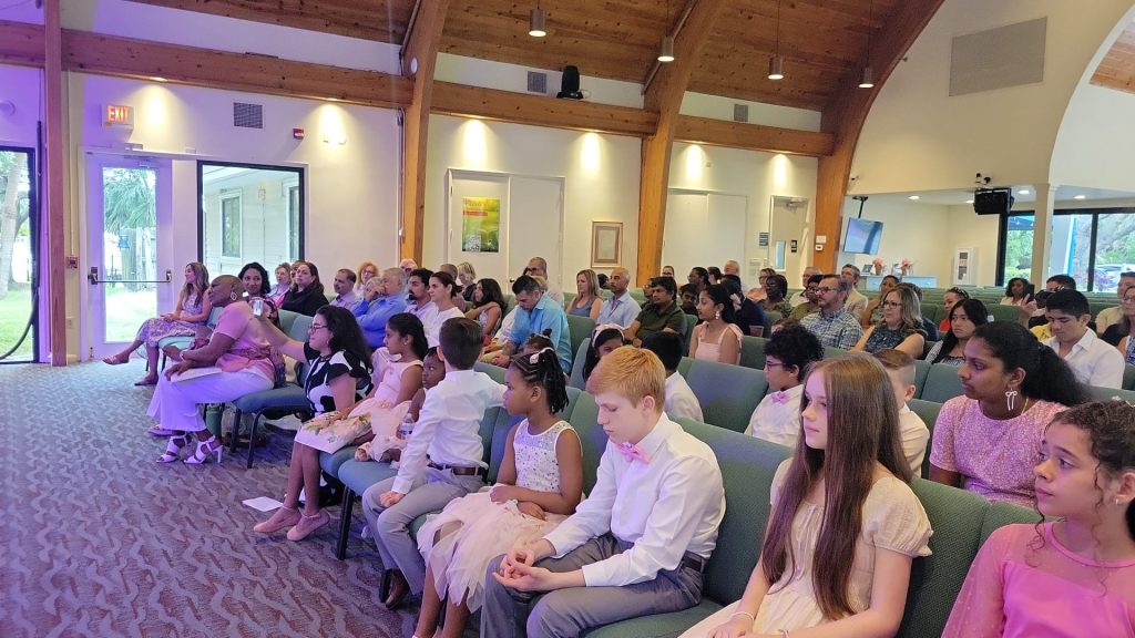 Vivia Taylor and her students in the audience at a music recital.