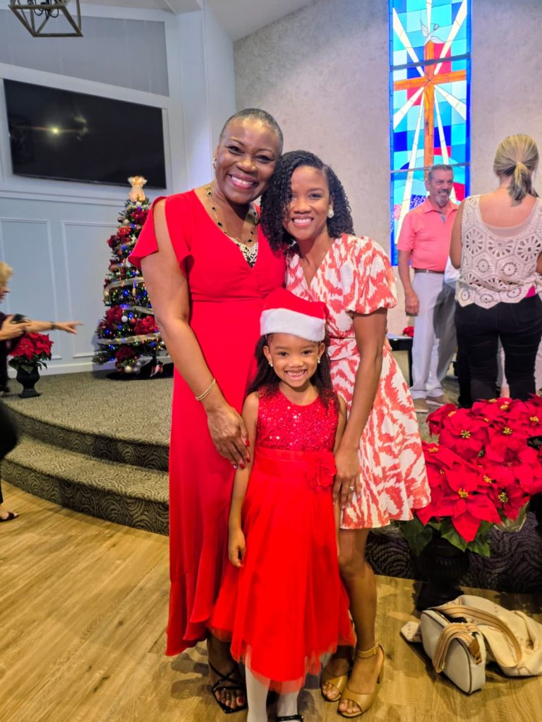 Vivia Taylor smiles with two students in a church during the 2025 Winter Recital.