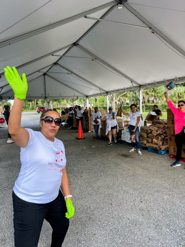 Music students and family members wave while volunteering for Feed the Hungry