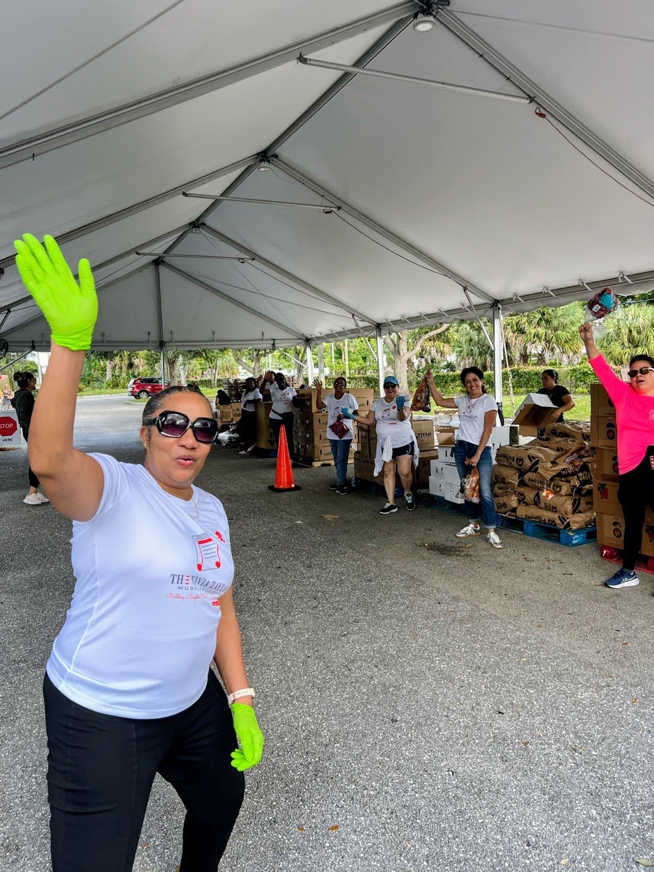 Music students and family members wave while volunteering for Feed the Hungry